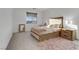 Cozy bedroom featuring carpeted floors, a plush rug, and a stylish upholstered bed frame at 10116 Rebel Coast St, Las Vegas, NV 89141