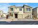 Two-story house with three-car garage, neutral color scheme, and landscaping at 10116 Rebel Coast St, Las Vegas, NV 89141