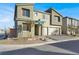 Two-story house with three-car garage and neutral color scheme at 10116 Rebel Coast St, Las Vegas, NV 89141