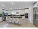 Modern kitchen boasts stainless steel appliances, island seating, and ample counter space at 10116 Rebel Coast St, Las Vegas, NV 89141