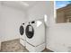 Convenient laundry room with modern side-by-side appliances and functional storage at 10116 Rebel Coast St, Las Vegas, NV 89141