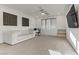 Spacious living room with white sofa, fan, and ample natural light at 10116 Rebel Coast St, Las Vegas, NV 89141