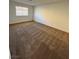 Bedroom with neutral carpet, baseboards, and natural light from the window at 1108 Smith St, Las Vegas, NV 89108