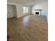 Spacious living room with wood flooring, a white-painted fireplace, and ample natural light at 1108 Smith St, Las Vegas, NV 89108