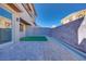 Private backyard with artificial turf and brick pavers at 11904 Vector Ray Ave, Las Vegas, NV 89138