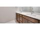 Double vanity bathroom with modern wood cabinets and quartz countertops at 11904 Vector Ray Ave, Las Vegas, NV 89138