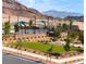 Community space with a pool, pergola, lawn, mature trees, and patio, creating a recreational oasis at 11904 Vector Ray Ave, Las Vegas, NV 89138