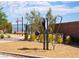 Community workout area with fitness equipment on wood chips and a walking path, encouraging an active lifestyle at 11904 Vector Ray Ave, Las Vegas, NV 89138