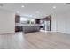 Modern kitchen with island, dark cabinetry and luxury vinyl flooring at 1225 Crimson Sunbird St, North Las Vegas, NV 89084