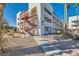 Exterior view of a two-story building with red metal stairs and landscaping at 1361 E University Ave # 209, Las Vegas, NV 89119