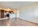 Living room with wood-look flooring and kitchen access at 1361 E University Ave # 209, Las Vegas, NV 89119