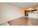 Living room with wood-look floors and view into kitchen at 1361 E University Ave # 209, Las Vegas, NV 89119