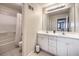 Bright bathroom featuring a double vanity with white cabinetry, a large mirror, and a shower-tub combination at 1420 S 8Th St, Las Vegas, NV 89104