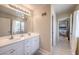 Bright bathroom featuring double sinks, ample counter space, and a connecting door to the bedroom at 1420 S 8Th St, Las Vegas, NV 89104