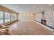 Spacious living room with stone fireplace, marble tile floors, and glass doors to the backyard pool at 1420 S 8Th St, Las Vegas, NV 89104