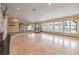 Bright living room with marble floors, stone fireplace, and multiple glass doors with views of the pool at 1420 S 8Th St, Las Vegas, NV 89104