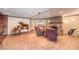 Cozy living room with stone fireplace, comfortable armchairs, grand piano, and wet bar at 1420 S 8Th St, Las Vegas, NV 89104