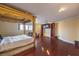 Bright main bedroom with hardwood floors, four-poster bed, and built-in bookshelves at 1420 S 8Th St, Las Vegas, NV 89104
