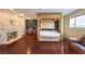 Large main bedroom suite with stone accent wall, hardwood floors, and natural light at 1420 S 8Th St, Las Vegas, NV 89104