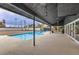 A covered outdoor patio overlooks a sparkling blue pool, perfect for relaxation and entertaining guests at 1420 S 8Th St, Las Vegas, NV 89104