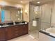 Elegant bathroom with double sinks, soaking tub, and shower at 145 E Harmon Ave # 2306, Las Vegas, NV 89109