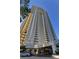 High rise building exterior with parking and landscaping at 145 E Harmon Ave # 2306, Las Vegas, NV 89109