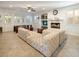 Bright living room featuring a fireplace, a tufted couch, and large windows at 1838 Country Meadows Dr, Henderson, NV 89012