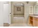Bathroom with a soaking tub, decorative wall art and shelving at 19 Via Visione # 204, Henderson, NV 89011