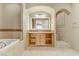 Elegant bathroom with soaking tub, double vanity, and tiled floors at 19 Via Visione # 204, Henderson, NV 89011