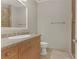 Light-filled bathroom with granite countertop vanity and tiled shower at 19 Via Visione # 204, Henderson, NV 89011