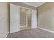 Spacious bedroom with plush carpeting and double doors leading to hallway at 19 Via Visione # 204, Henderson, NV 89011