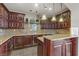 Well-equipped kitchen with dark wood cabinets and granite counters at 19 Via Visione # 204, Henderson, NV 89011