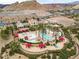 Luxury community pool and spa with palm trees and red umbrellas at 19 Via Visione # 204, Henderson, NV 89011