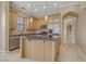 Modern kitchen with granite island, wood cabinets and stainless appliances at 19 Via Visione # 204, Henderson, NV 89011