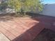 Small backyard with a brick patio and a partially shaded grassy area at 1905 Weldon Pl, Las Vegas, NV 89104