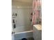 Bathroom with a shower/tub combo, built-in shelving and a pineapple shower curtain at 1905 Weldon Pl, Las Vegas, NV 89104
