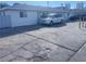 Front view of a single story home with a spacious driveway and parking area at 1905 Weldon Pl, Las Vegas, NV 89104