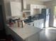 Bright kitchen featuring white shaker cabinets, quartz countertops, and stainless steel appliances at 1905 Weldon Pl, Las Vegas, NV 89104