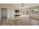 Open living room with hardwood floors, a ceiling fan, and natural light from sliding glass doors at 2816 Bent Tree Ct, Las Vegas, NV 89134