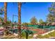 Active community featuring well-maintained tennis courts with lush landscaping around the fenced perimeter at 2816 Bent Tree Ct, Las Vegas, NV 89134