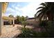 Landscaped backyard with patio, palm trees, and gravel at 3390 Syvella Ct, Las Vegas, NV 89117