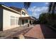 Large backyard with covered patio, flagstone, and desert landscaping at 3390 Syvella Ct, Las Vegas, NV 89117
