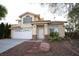 Two-story house with a brick facade, attached garage, and landscaped yard at 3390 Syvella Ct, Las Vegas, NV 89117