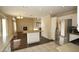 Open kitchen with island, stainless steel appliances, and dark floors at 3390 Syvella Ct, Las Vegas, NV 89117