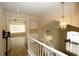 Upstairs hallway with open railing and view to living area at 3390 Syvella Ct, Las Vegas, NV 89117