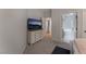 Bedroom with TV, dresser, and access to bathroom and laundry at 3975 N Hualapai Way # 266, Las Vegas, NV 89129