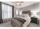 Main bedroom with plush bed and window curtains at 3975 N Hualapai Way # 266, Las Vegas, NV 89129