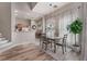 Charming dining area with a rustic table and chairs, complemented by a stylish chandelier at 3975 N Hualapai Way # 266, Las Vegas, NV 89129