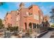 Spanish-style townhome with a two-story elevation, featuring a modern color scheme and landscaping at 3975 N Hualapai Way # 266, Las Vegas, NV 89129