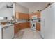 Well-equipped kitchen with light wood cabinets and white appliances at 3975 N Hualapai Way # 266, Las Vegas, NV 89129